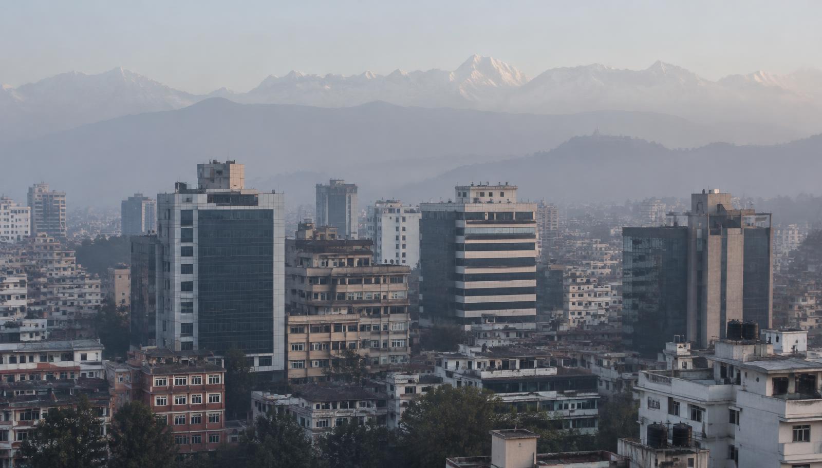 The Kathmandu business district in morning haze with the Himalayan range in the distance